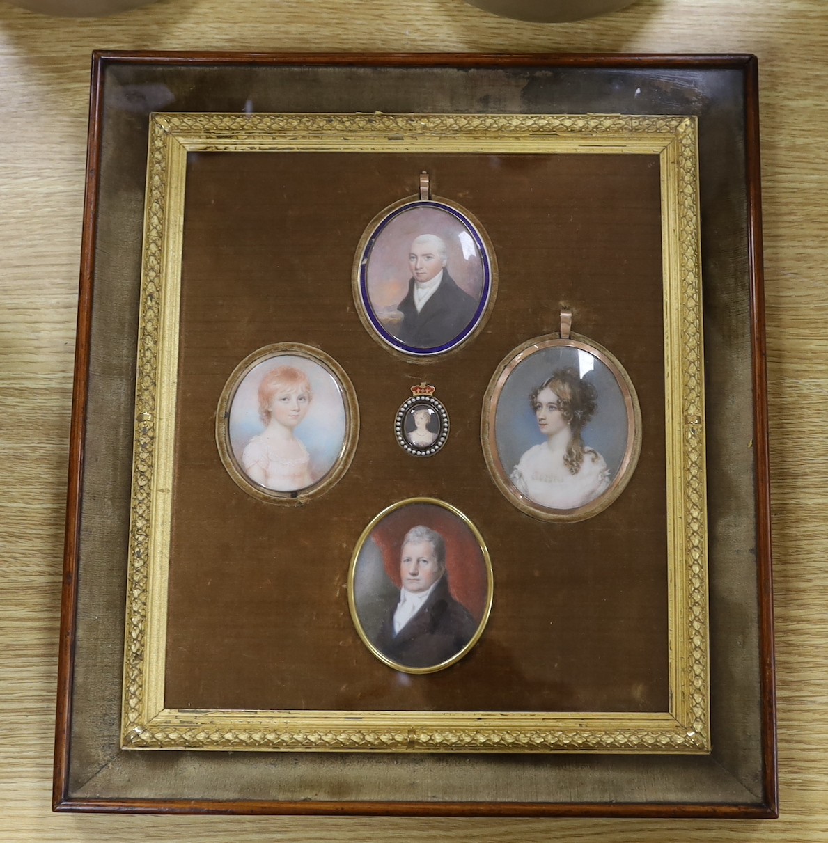 A group of five 19th century portrait miniatures on ivory, framed as one, in a decorative gilt and velvet mount rosewood frame. Overall 36 x 32cm